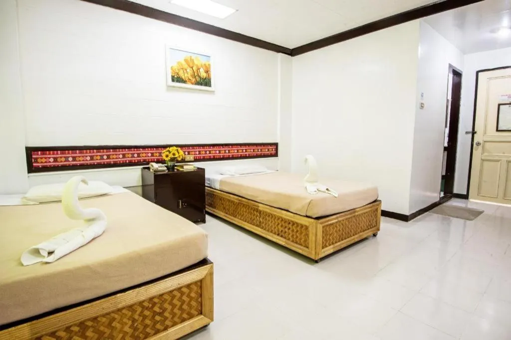 Bed in Family Country Hotel and Convention Centre