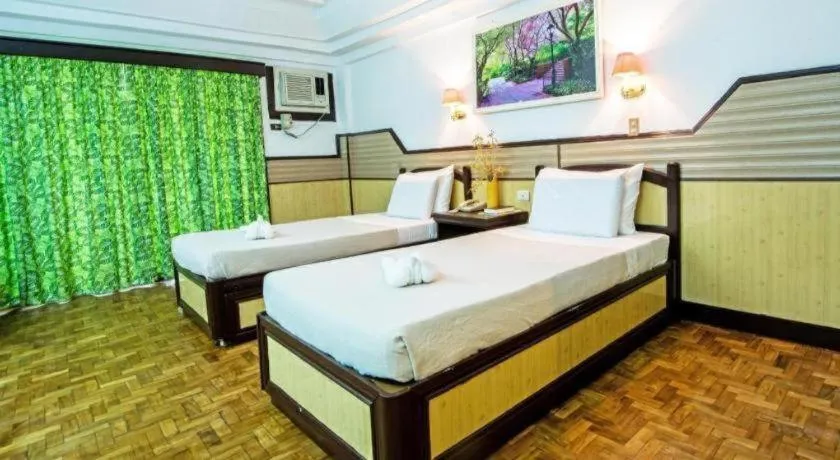 Bed in Family Country Hotel and Convention Centre