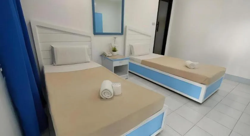 Bed in Family Country Hotel and Convention Centre