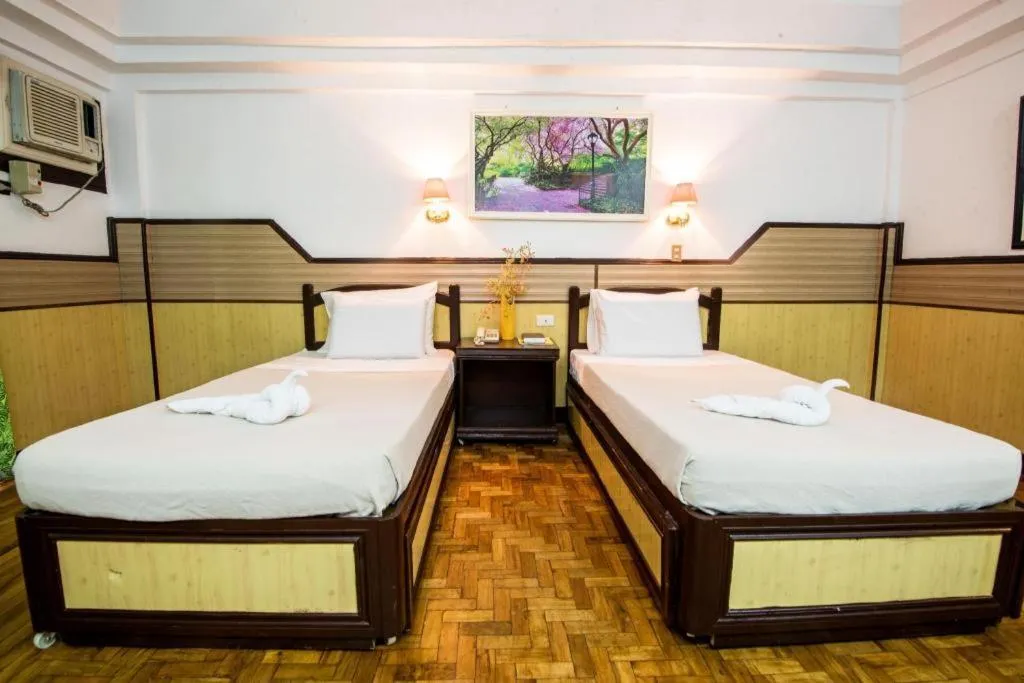 Bed in Family Country Hotel and Convention Centre