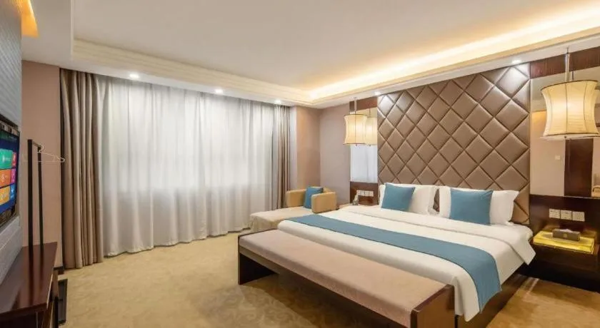 Bed in Aksu Pudong Holiday Hotel