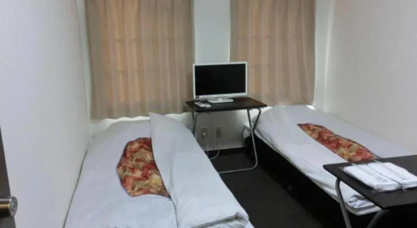 Bed in New Shochikubai Hotel