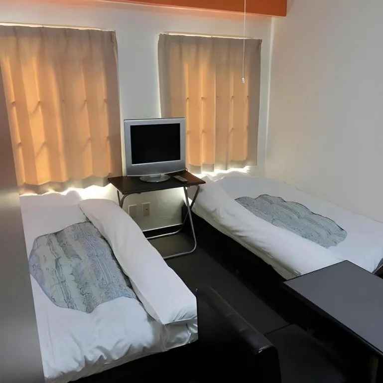 Bed in New Shochikubai Hotel