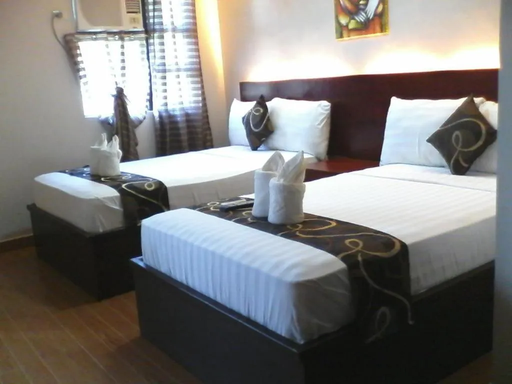 Bed in Rovic's Tourist Hotel