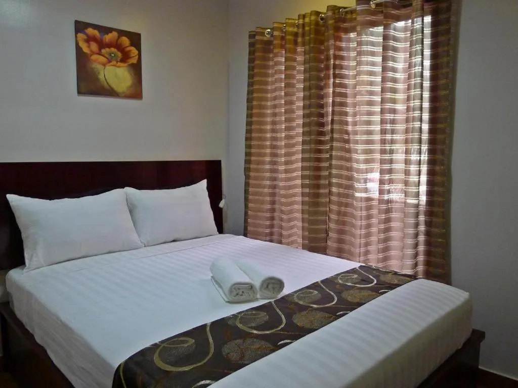 Bed in Rovic's Tourist Hotel