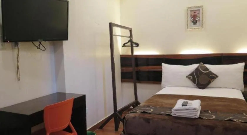 Bed in Rovic's Tourist Hotel