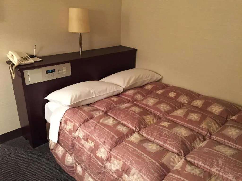 Bed in Hotel Town Nishikigawa