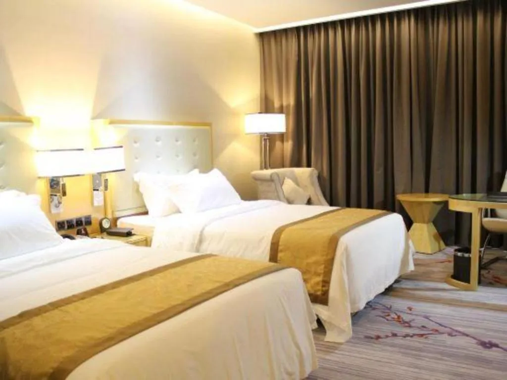 Bed in Golden Phoenix International Hotel