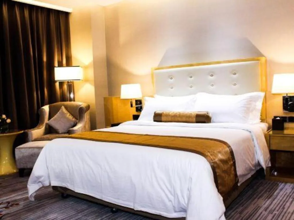Bed in Golden Phoenix International Hotel