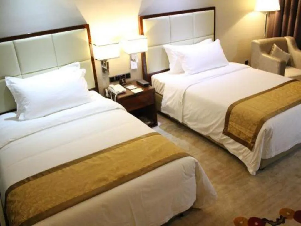 Bed in Golden Phoenix International Hotel