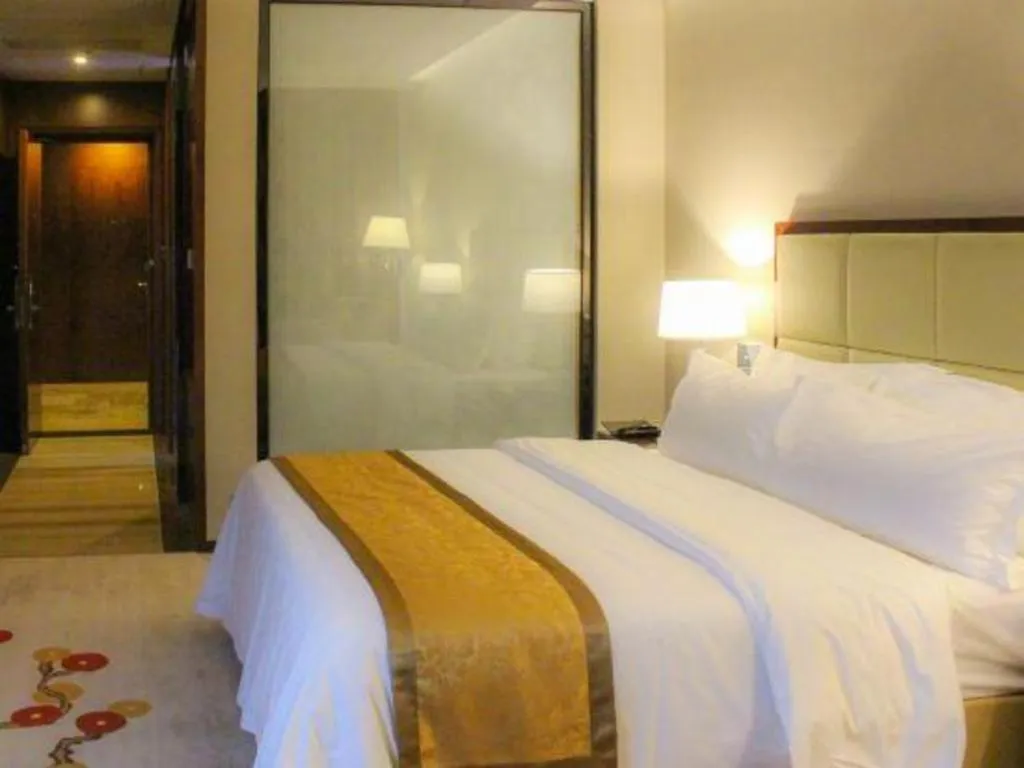Bed in Golden Phoenix International Hotel