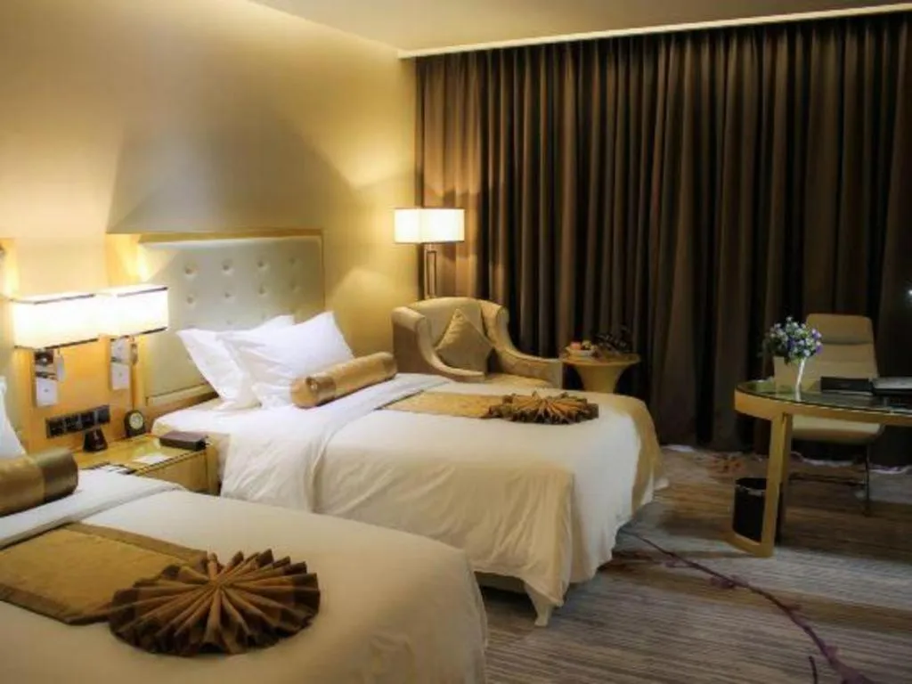 Bed in Golden Phoenix International Hotel