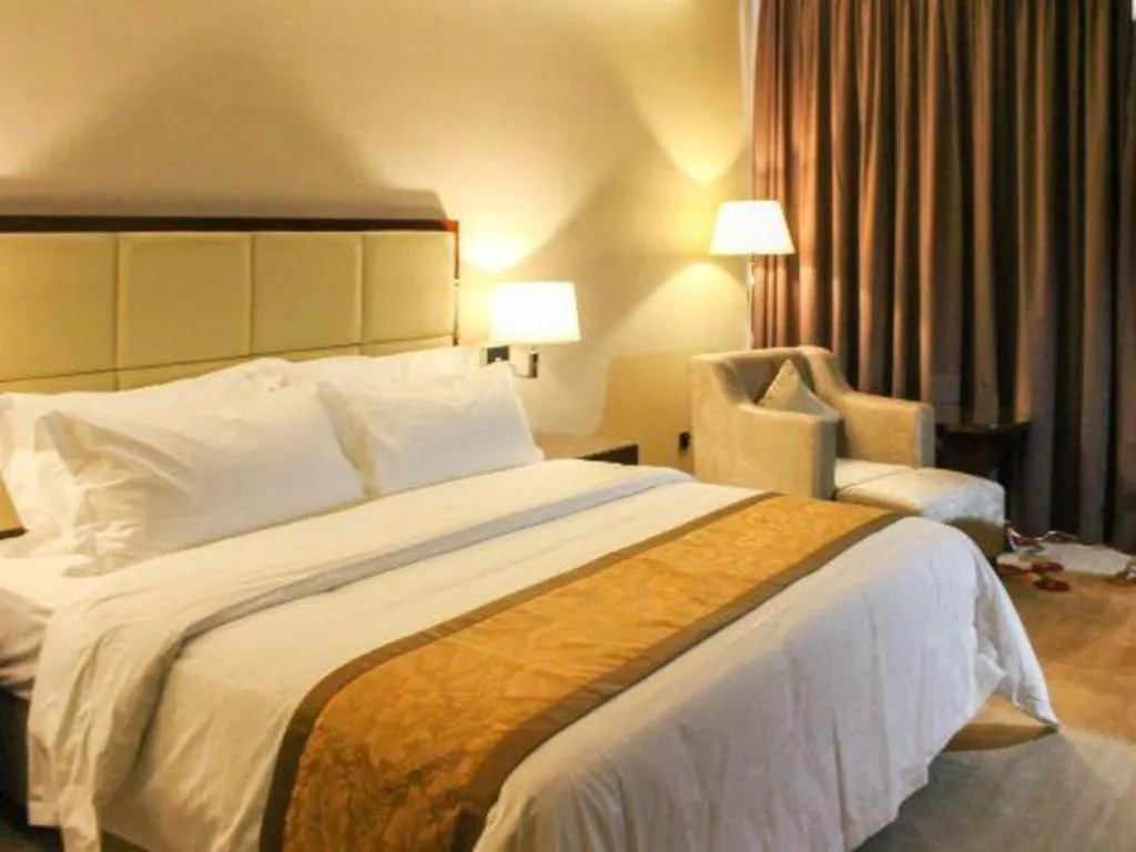 Bed in Golden Phoenix International Hotel