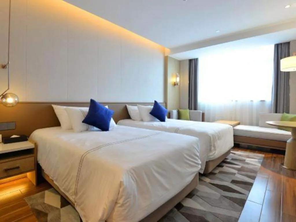 Bed in AUGUSTINE HOTEL