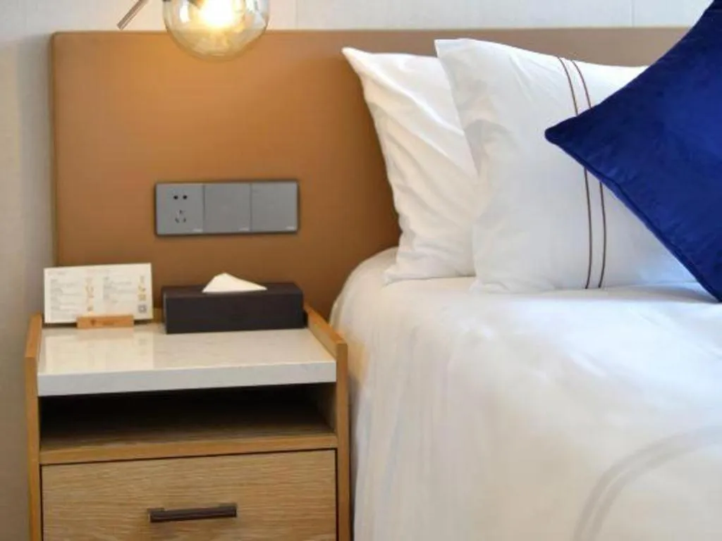 Bed in AUGUSTINE HOTEL