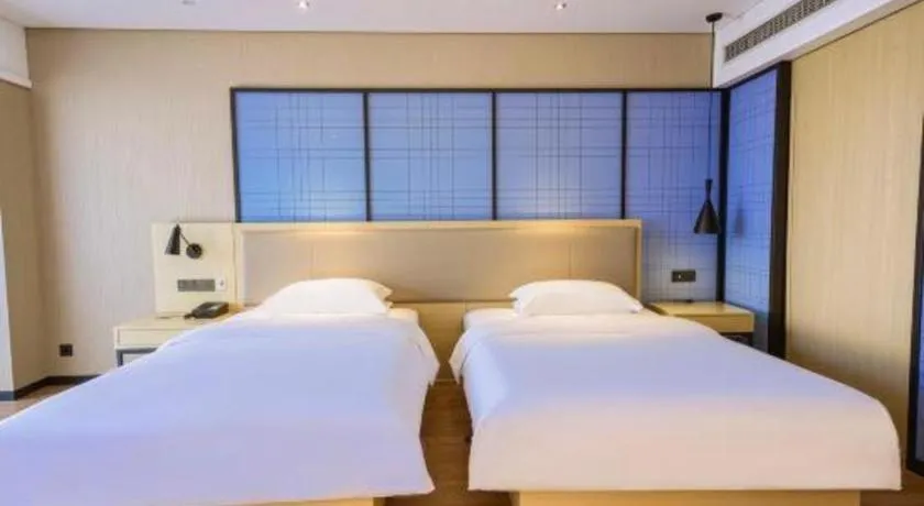 Bed in Echarm Hotel Aegean Shopping Park Zhonghuan Plaza