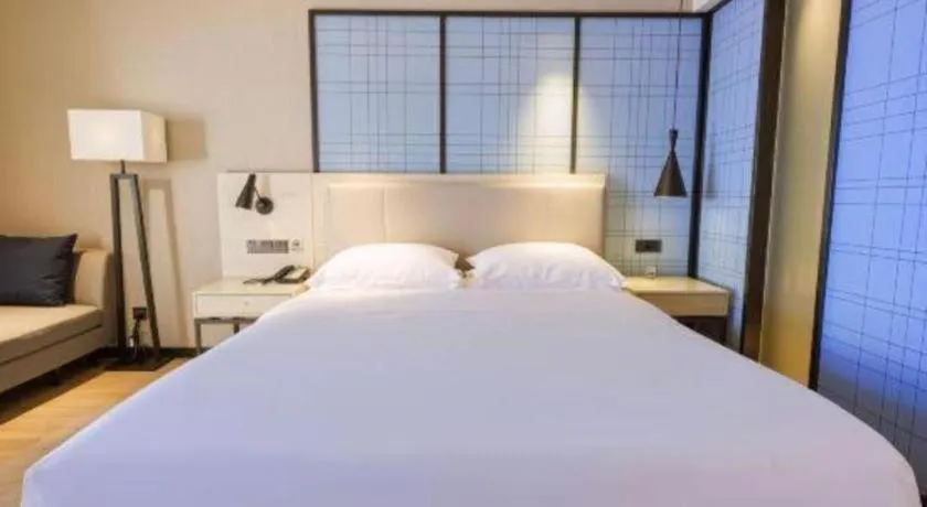 Bed in Echarm Hotel Aegean Shopping Park Zhonghuan Plaza