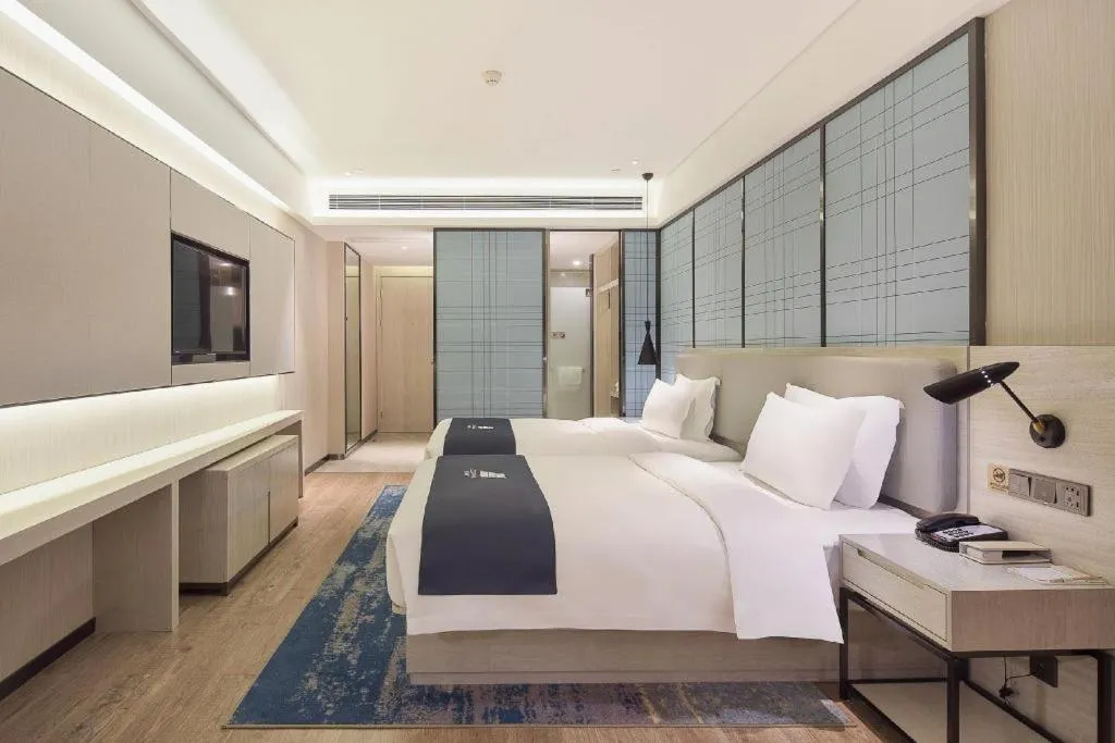 Bed in Echarm Hotel Changsha Guihua Park Metro Station