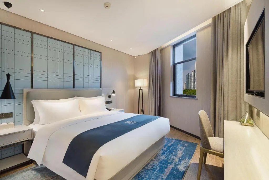 Bed in Echarm Hotel Changsha Guihua Park Metro Station
