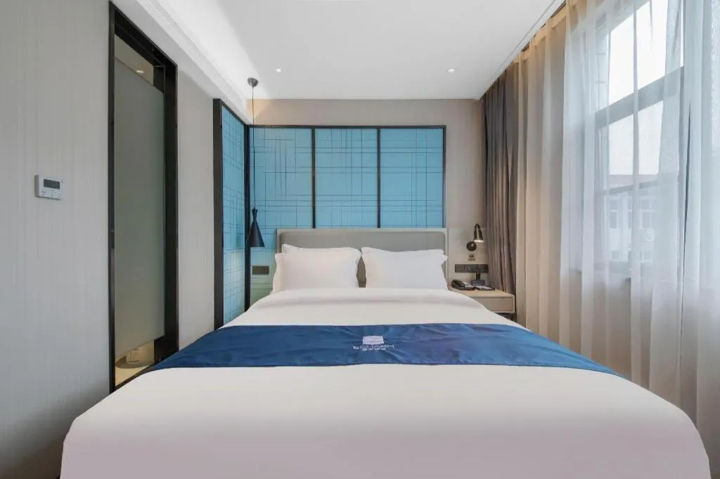 Bed in Echarm Hotel Xinyu Railway Station Baoshi Park