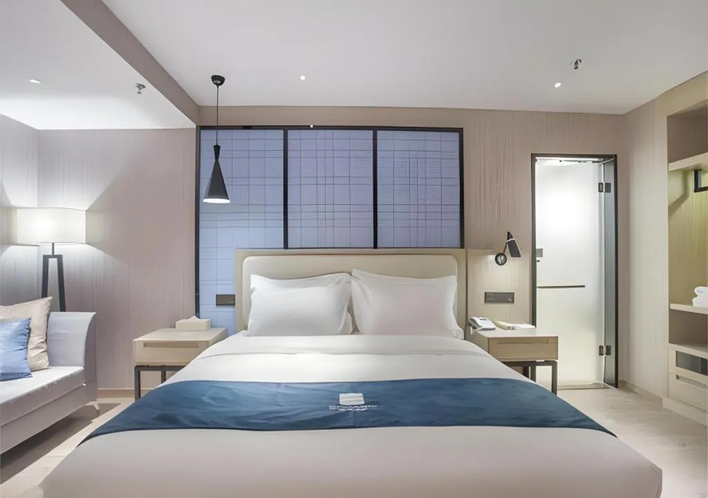 Bed in Echarm Hotel Xinyu Railway Station Baoshi Park