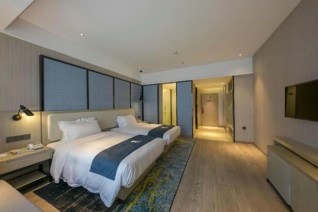 Bed in Echarm Hotel Xinyu Railway Station Baoshi Park