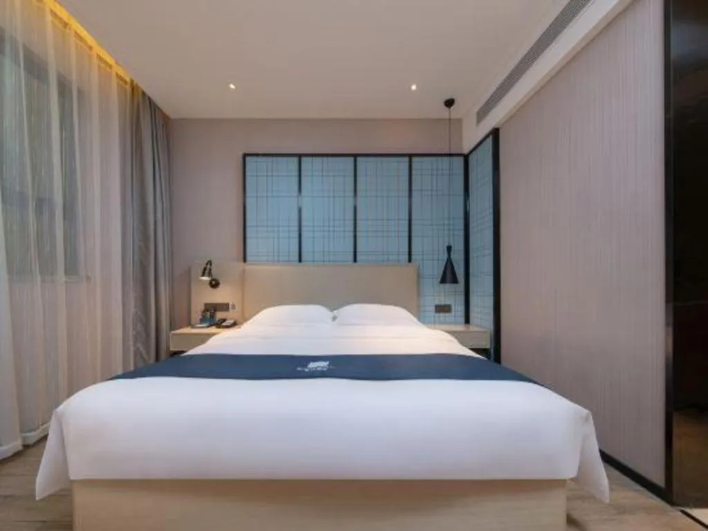 Bed in Echarm Hotel Xinyu Railway Station Baoshi Park