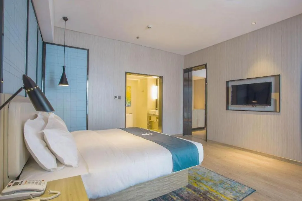 Bed in Echarm Hotel Xinyu Railway Station Baoshi Park