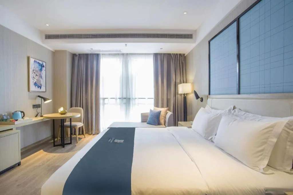 Bed in Echarm Hotel Xinyu Railway Station Baoshi Park