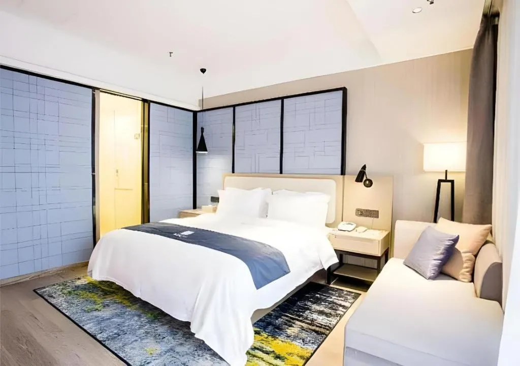 Bed in Echarm Hotel Xinyu Railway Station Baoshi Park