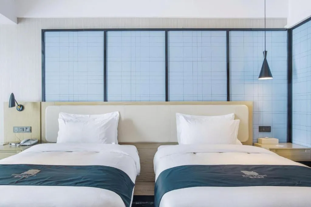 Bed in Echarm Hotel Xinyu Railway Station Baoshi Park
