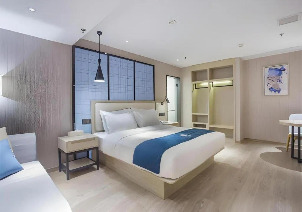 Bed in Echarm Hotel Xinyu Railway Station Baoshi Park