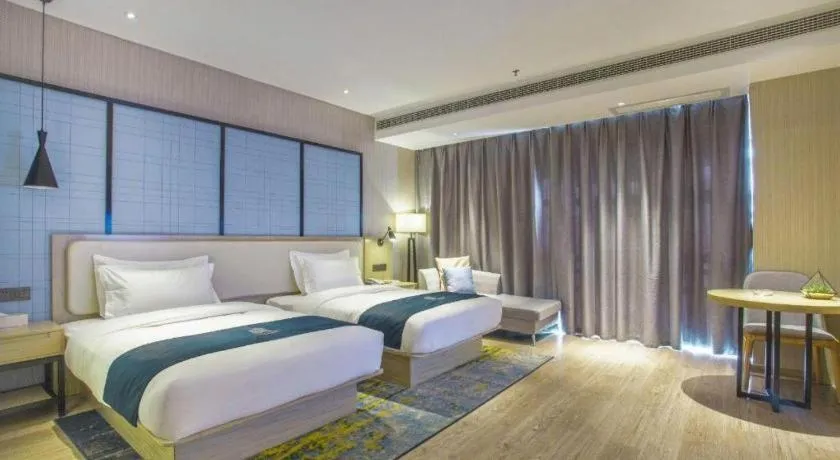 Bed in Echarm Hotel Xinyu Railway Station Baoshi Park