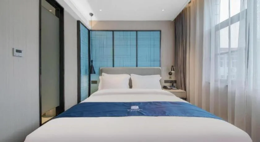 Bed in Echarm Hotel Xinyu Railway Station Baoshi Park