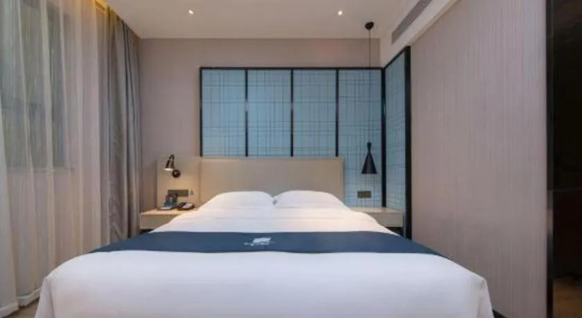 Bed in Echarm Hotel Xinyu Railway Station Baoshi Park