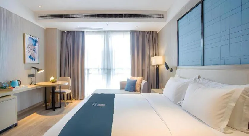 Bed in Echarm Hotel Xinyu Railway Station Baoshi Park