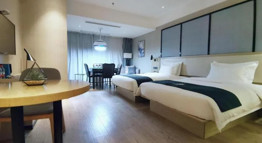 Bed in Echarm Hotel Xinyu Railway Station Baoshi Park