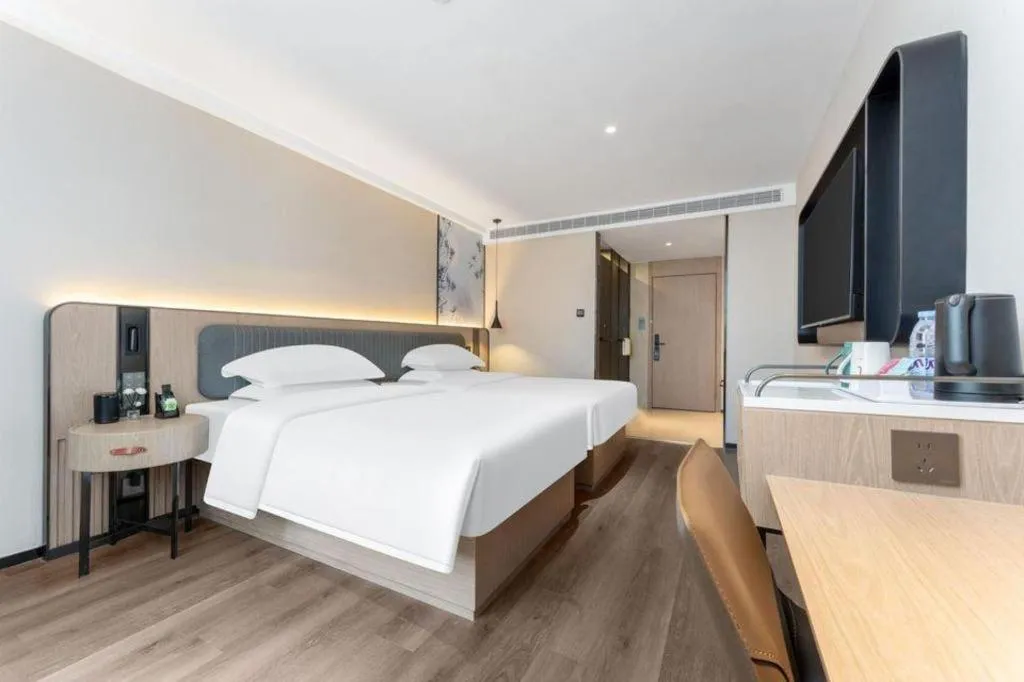 Bed in Echarm Hotel Wuhan Vanke Future Center Wulidun Metro Station