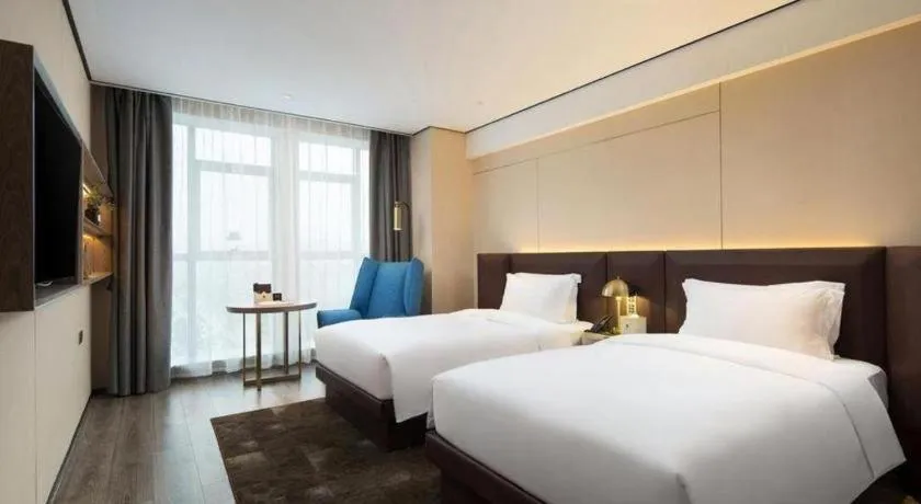 Bed in Echarm Plus Hotel Changsha High-speed Railway South Station Desiqin