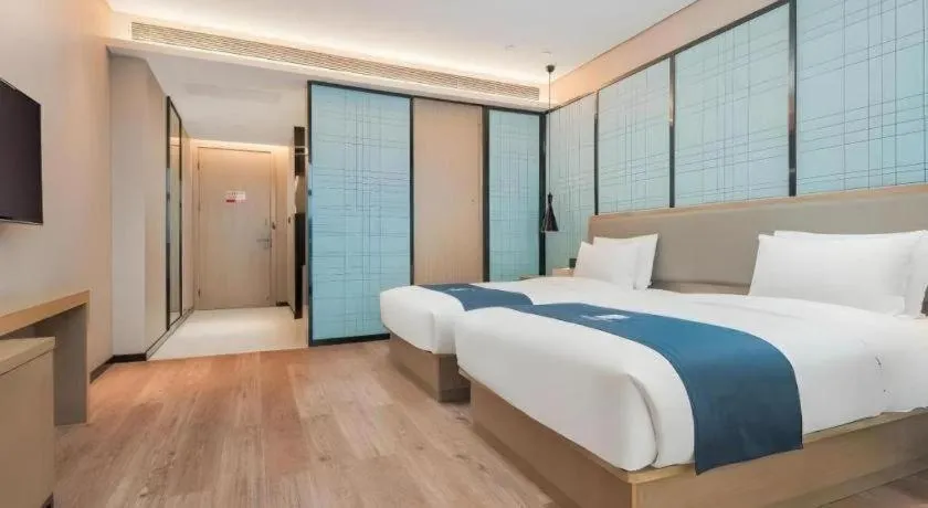 Bed in Echarm Hotel Liuzhou Liunan Wanda Plaza