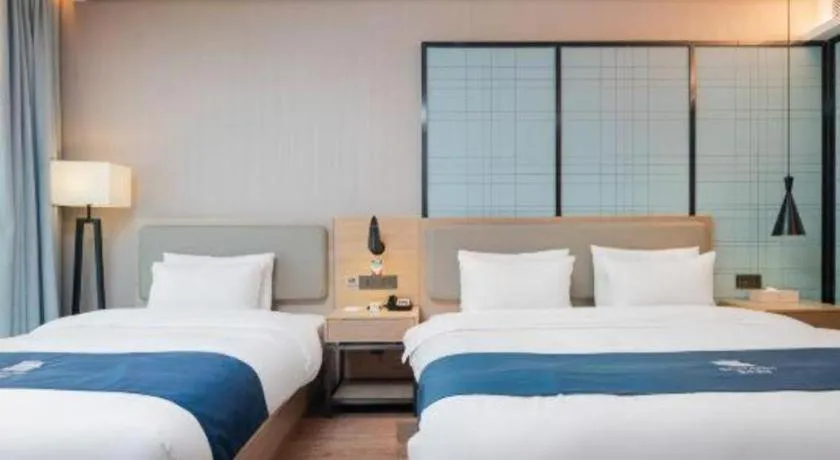 Bed in Echarm Hotel Liuzhou Liunan Wanda Plaza