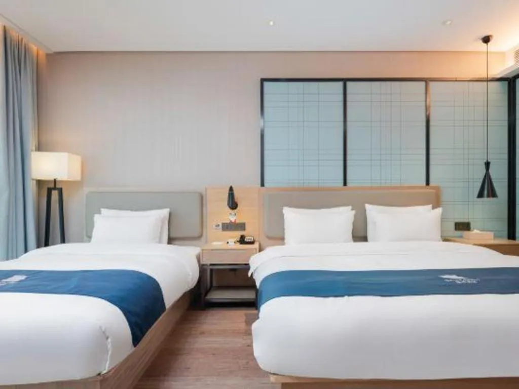 Bed in Echarm Hotel Liuzhou Liunan Wanda Plaza