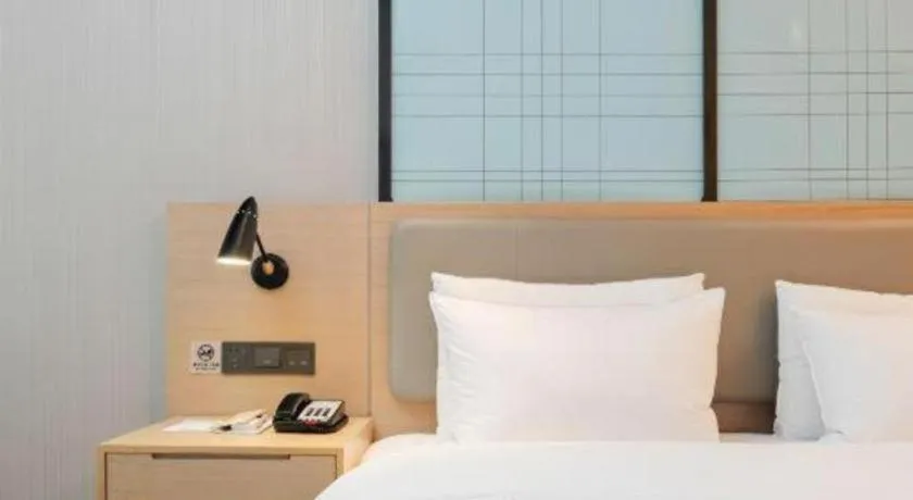 Bed in Echarm Hotel Liuzhou Liunan Wanda Plaza