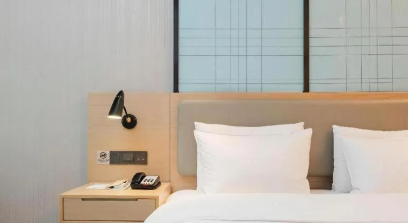 Bed in Echarm Hotel Liuzhou Liunan Wanda Plaza