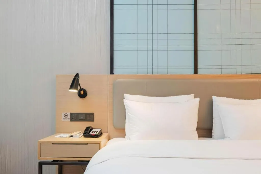 Bed in Echarm Hotel Liuzhou Liunan Wanda Plaza