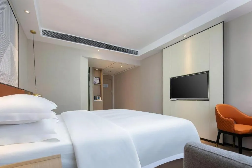 Bed in Borrman Hotel Qianjiang High-speed Railway Station Lobster City