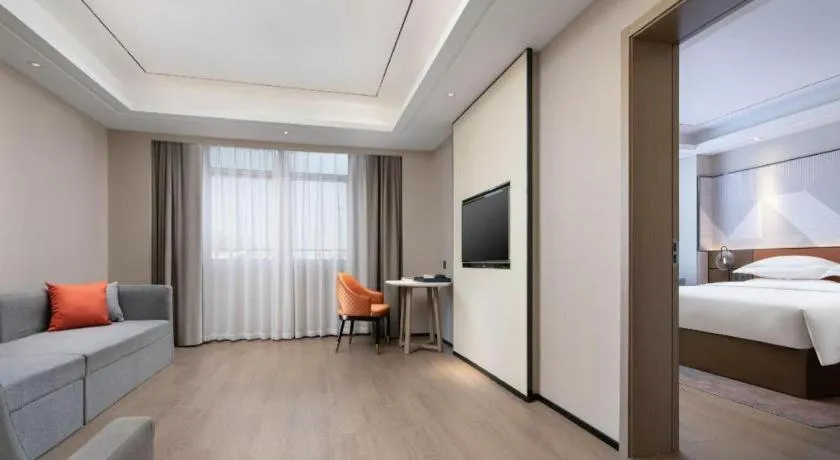 Bed in Borrman Hotel Qianjiang High-speed Railway Station Lobster City