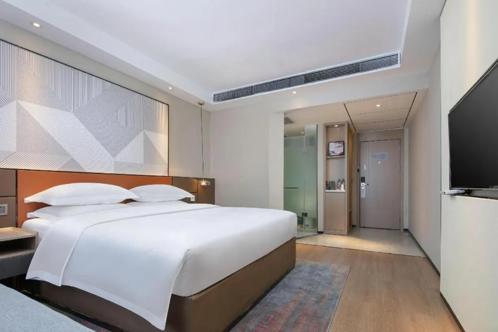 Bed in Borrman Hotel Qianjiang High-speed Railway Station Lobster City