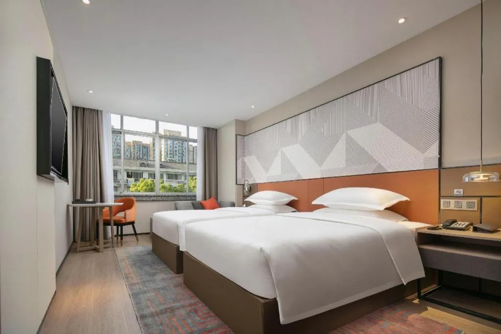 Bed in Borrman Hotel Qianjiang High-speed Railway Station Lobster City