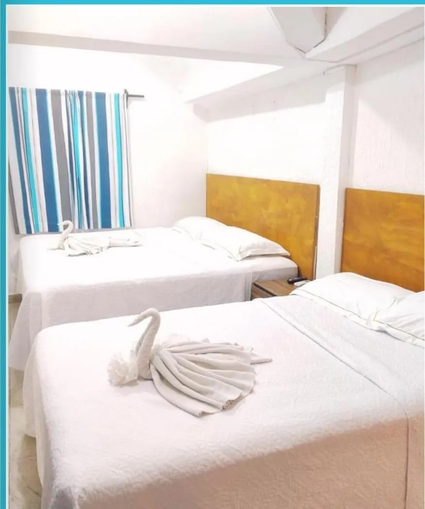 Bed in Íkaro Suites Cancún